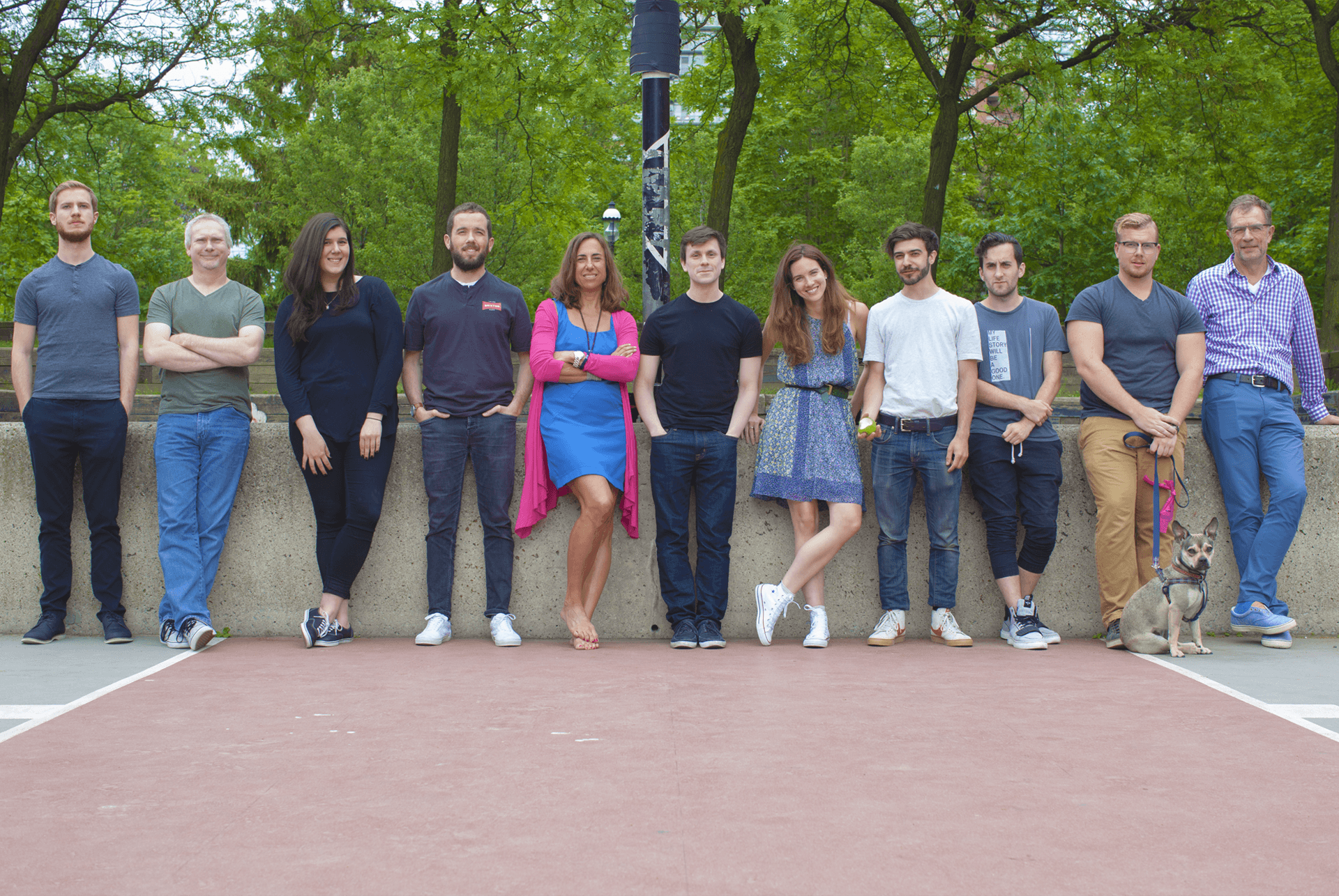 The Q teams stands outside for a Q photo