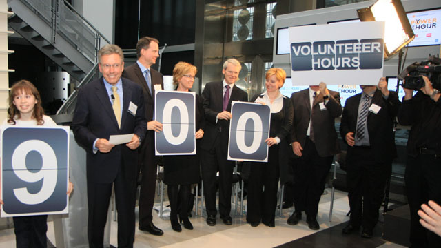 Our Power of the Hour Campaign participants holding up their volunteer hours