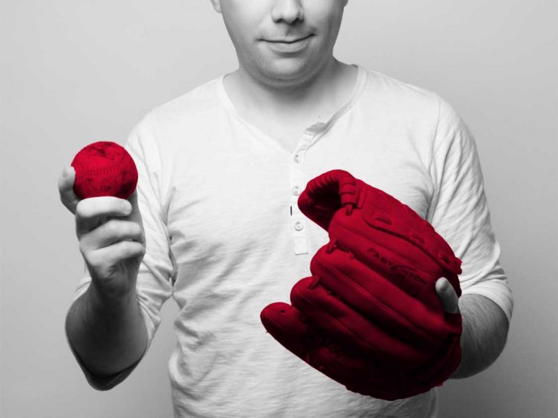 Image of Jeremy McCracken and his "q media red" baseball glove and ball. He is a lifelong fan of baseball.