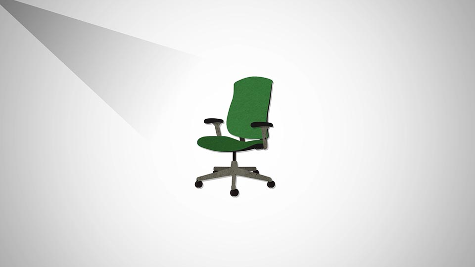 An animated green chair sits in the middle of a white space.