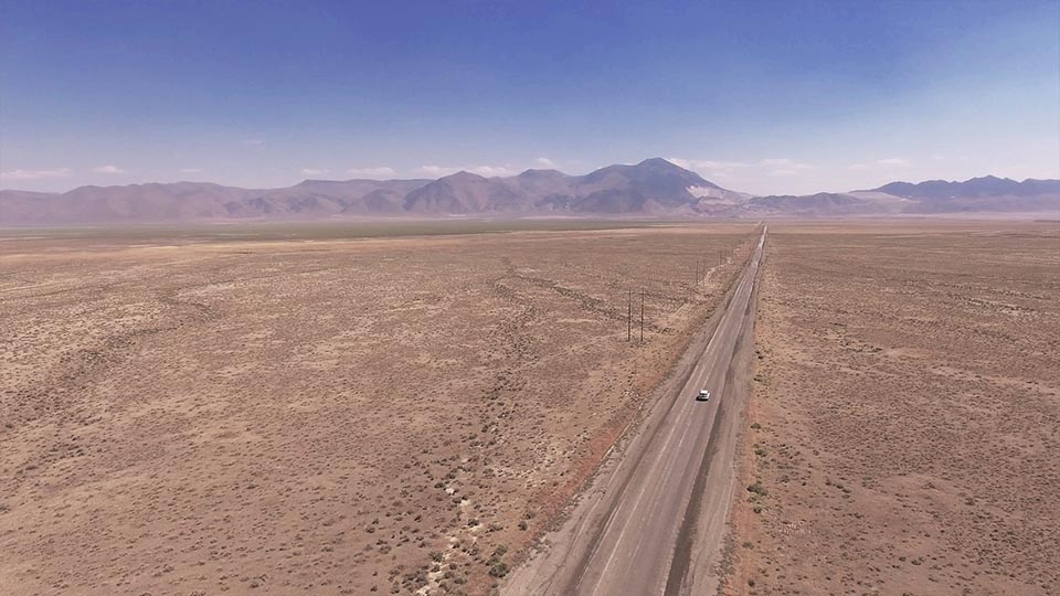 drone shot of a long road
